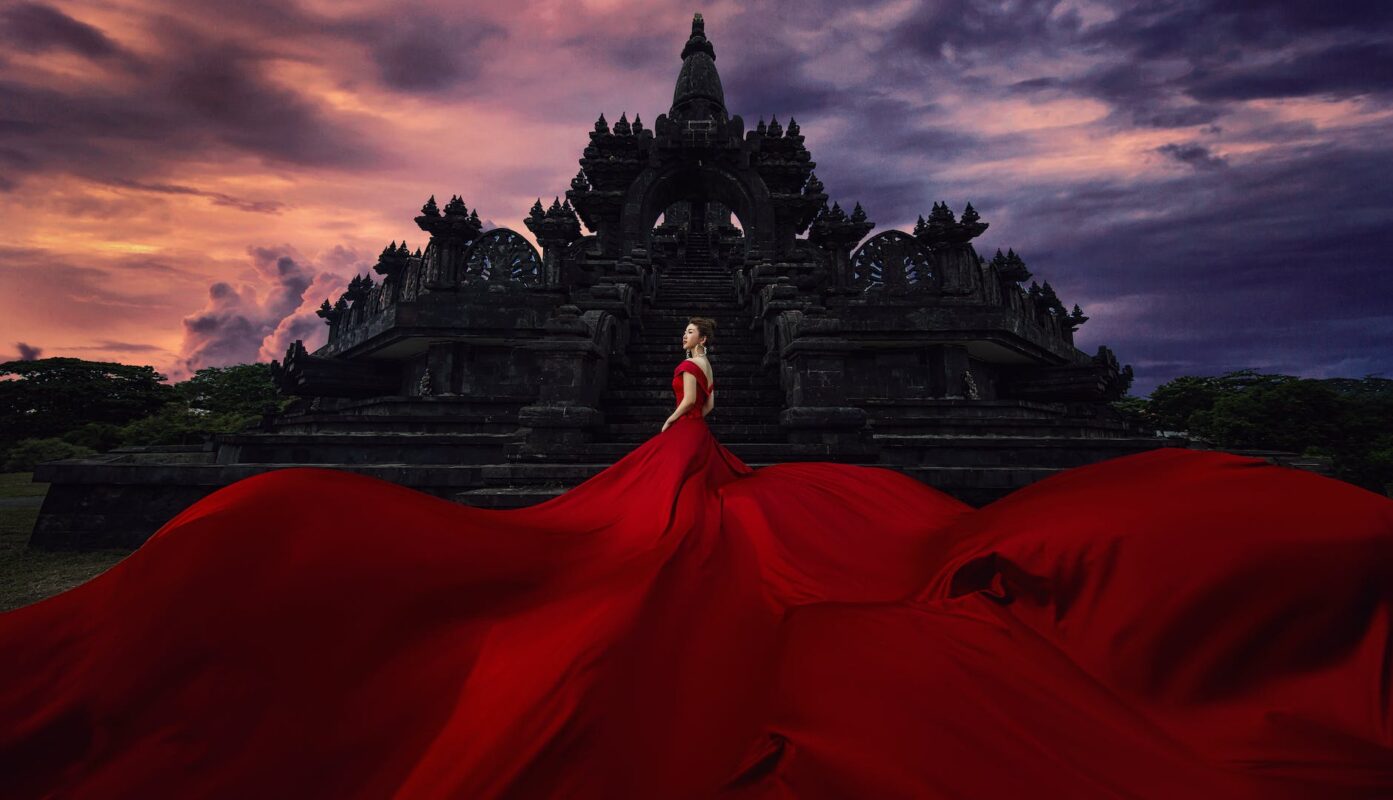 woman wearing red log dress outside building